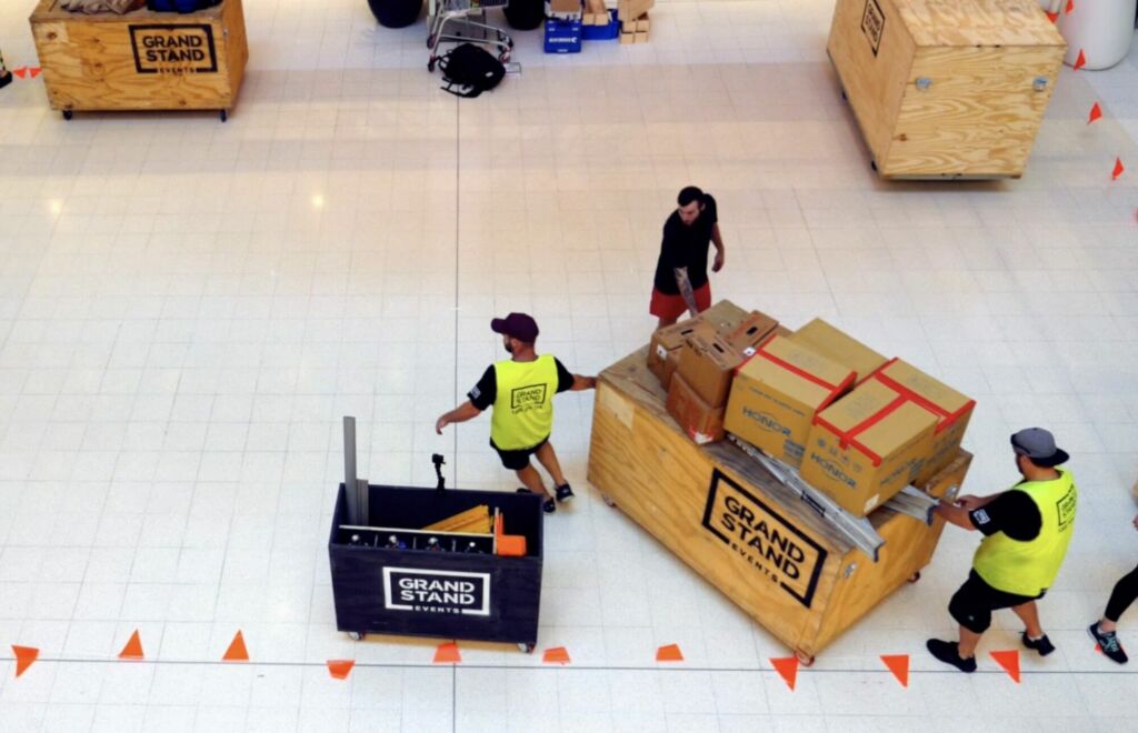 Build Team carting crates of equipment through Westfield for a pop up activation