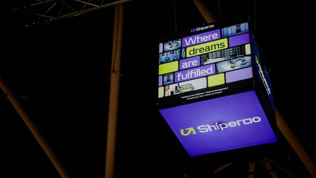 Bright LED Signage Cube against dark exhibition hall ceiling