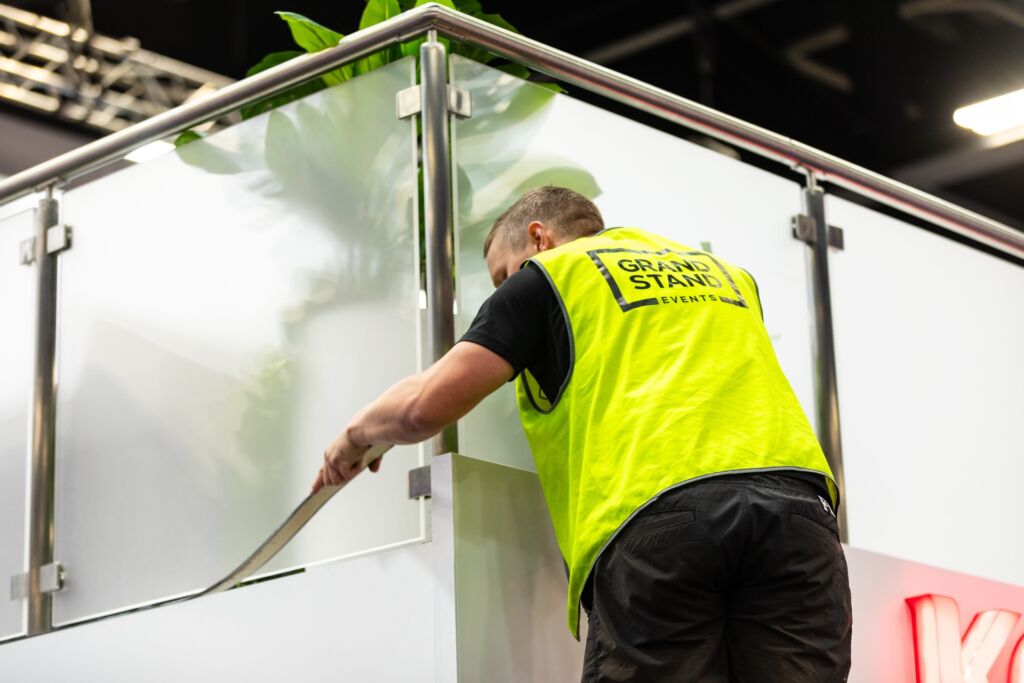 Grand Stand Events team installing custom mezzanine balustrade cladding