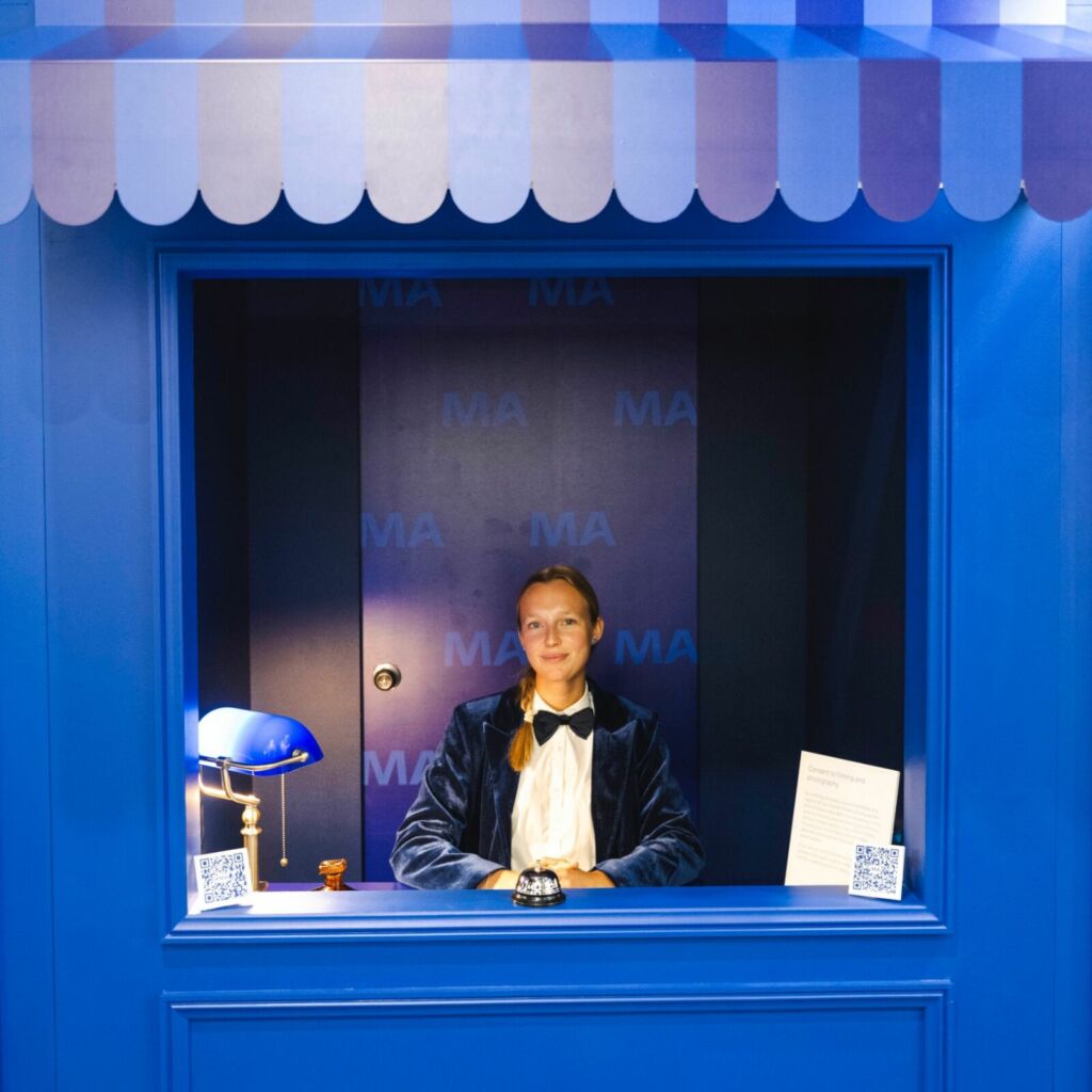 branded reception hut with greeting staff