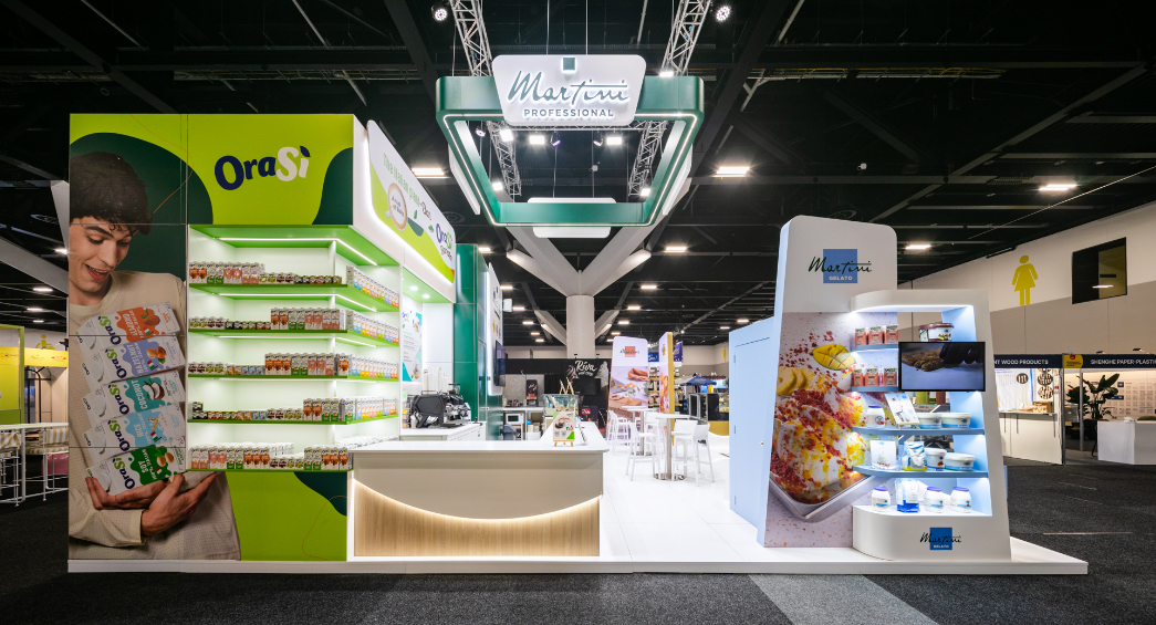 Custom island exhibition stand panorama featuring bespoke plant-based milk display wall, barista counter, and freestanding gelato product unit built for Martini Professional at Restaurant & Foodservice Show Australia 2026
